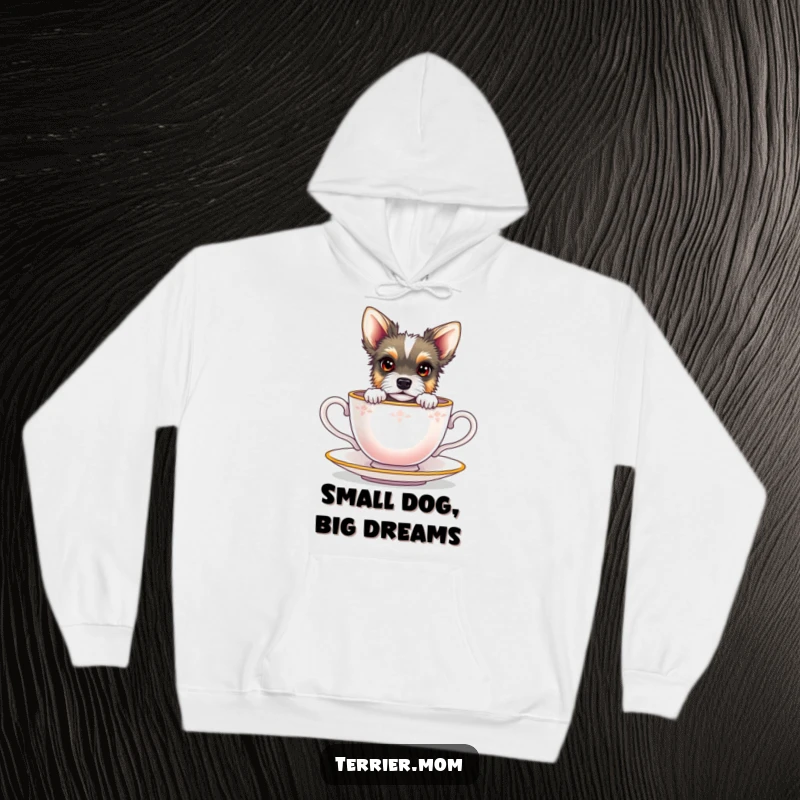 Funny terrier with bright eyes peeking from a miniature teacup, featured on a cozy hoodie.