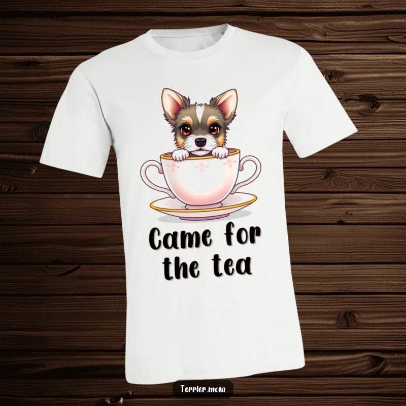 Funny terrier with bright eyes peeking out from a miniature teacup, printed on a soft t-shirt.